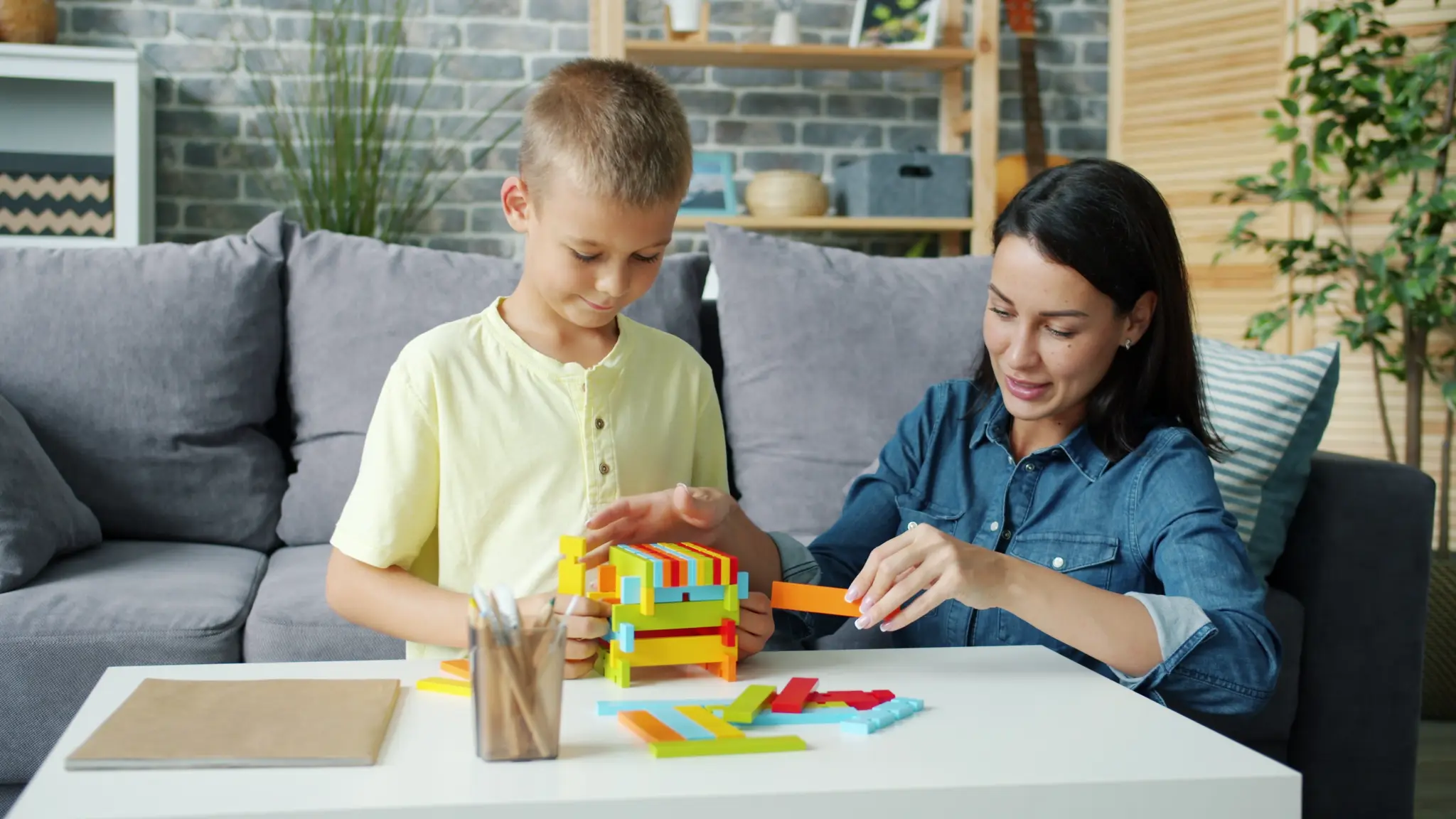 Illustrative lifestyle scene of a child learning through play with a supportive adult at home