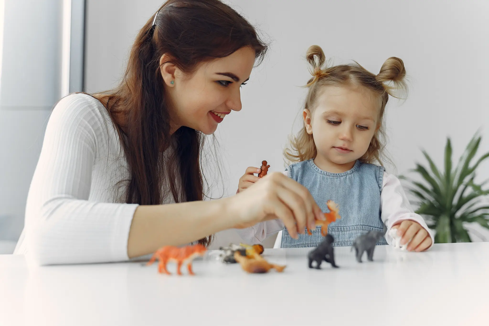Illustrative lifestyle scene of a child learning through play with a supportive adult at home
