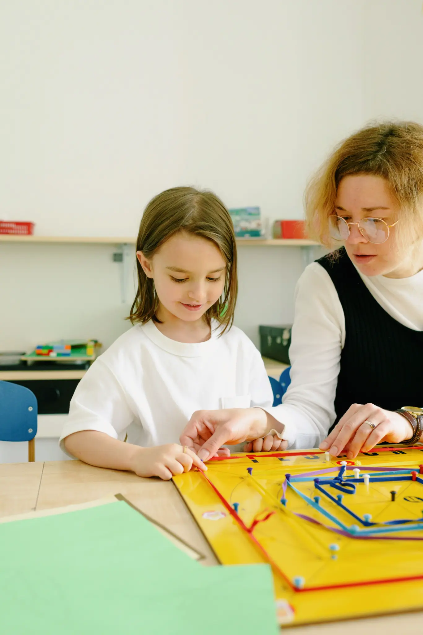 Illustrative lifestyle scene of a child learning through play with a supportive adult at home