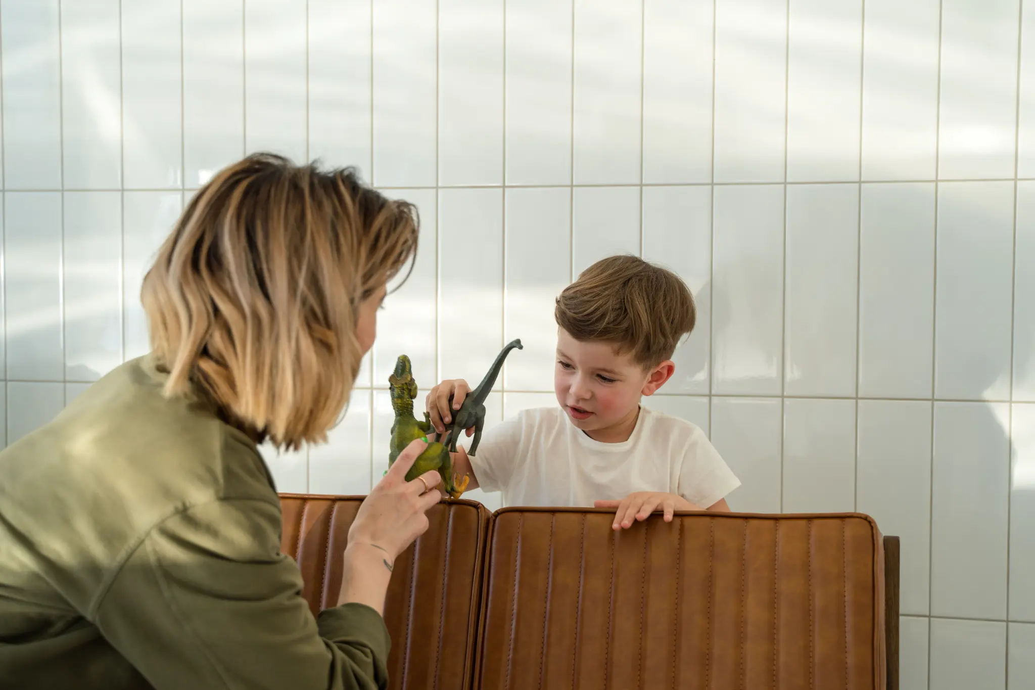 Illustrative lifestyle scene of a child learning through play with a supportive adult at home